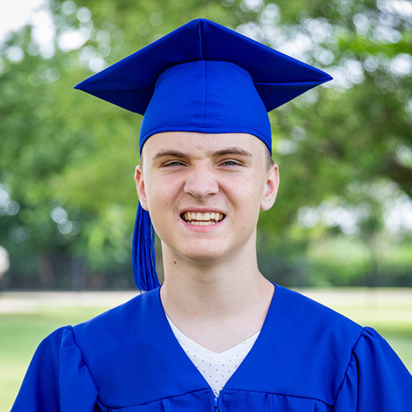 Portrait of Stone wearing a graduation cap and gown