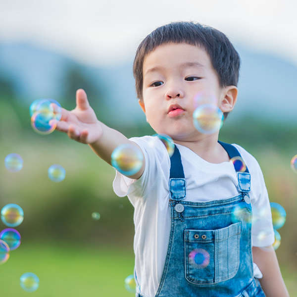 Boy playing with bubbles