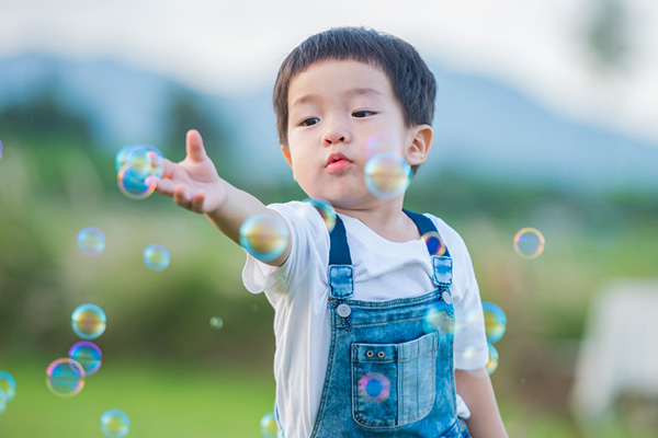 Boy playing with bubbles