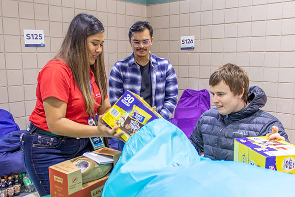 Spirit AeroSystems employees opening gifts with Heartspring students