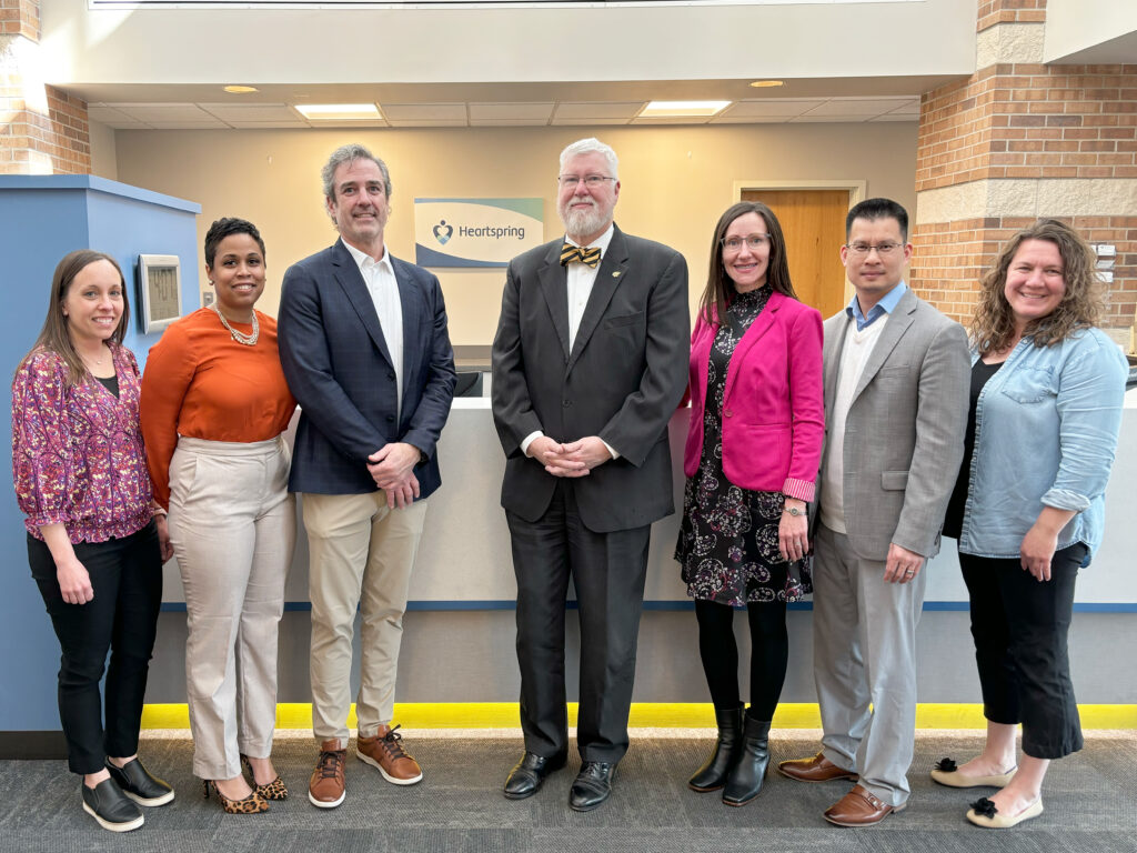 Members of Heartspring's leadership team and Dr. Gregory Hand