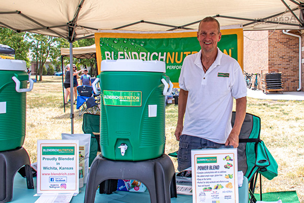 Steve Richards standing in the Blendrich Nutrition vendor booth at Heartspring's PedalFest event