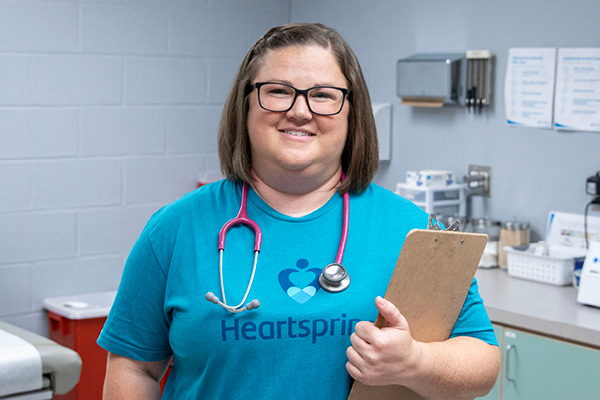 Portrait of Chelsea Schroeder holding a clipboard and wearing a stethoscope