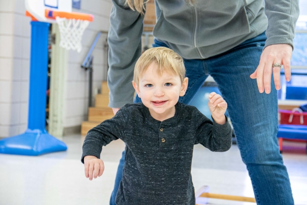 Heartspring client walking during a pediatric physical therapy session