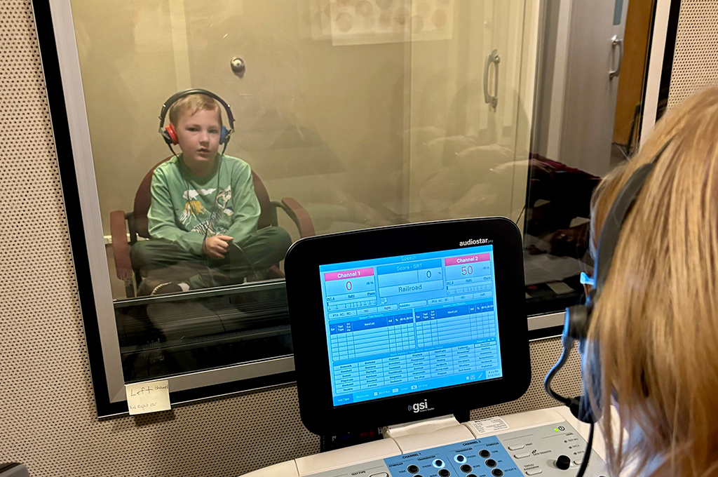 Pediatric audiologists tests the hearing of a Heartspring client
