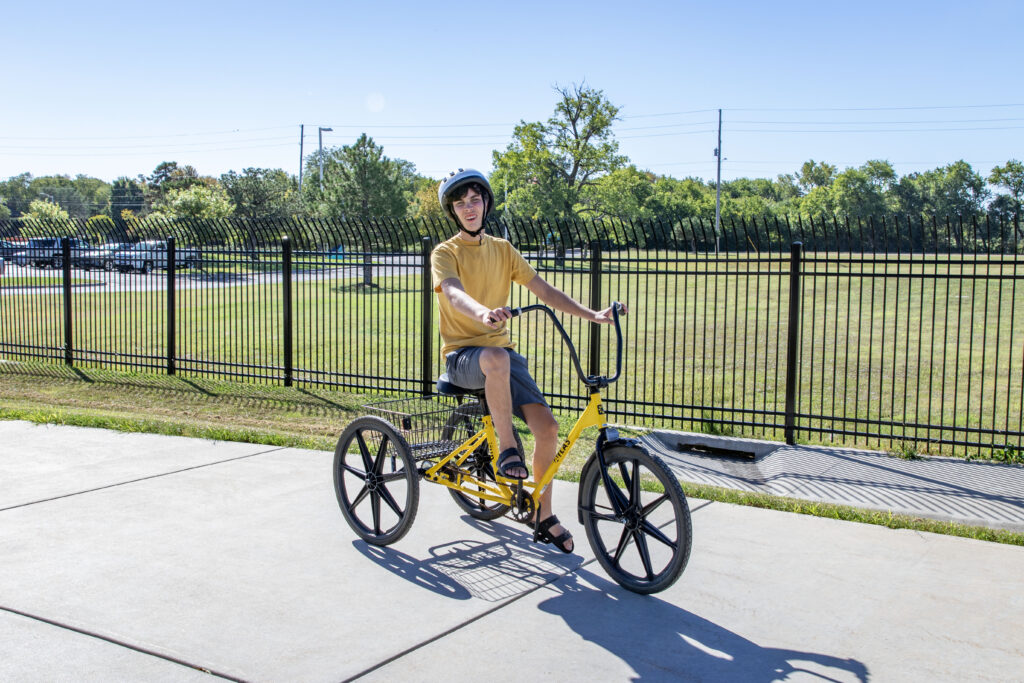 Heartspring student riding a trike