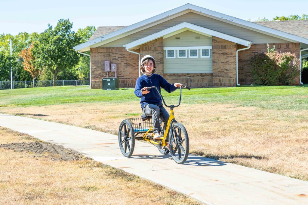 Student in the Therapeutic Residential & Day School rides a bike.