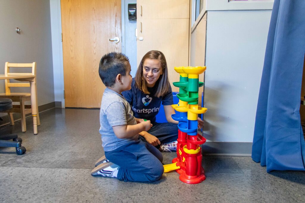 Heartspring speech-language therapist and client in an early intervention therapy session