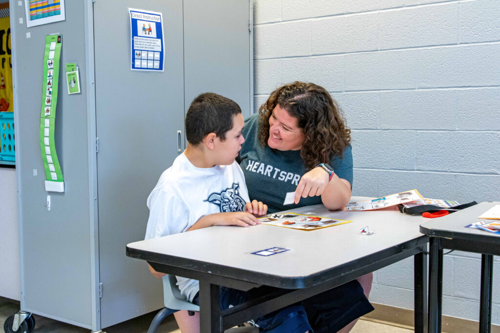 Heartspring therapeutic school special education teacher working with a student in a classroom