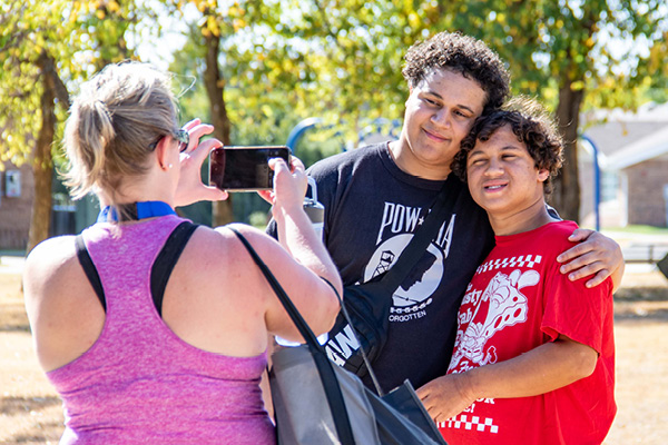 Heartspring parent taking a photo of her sons