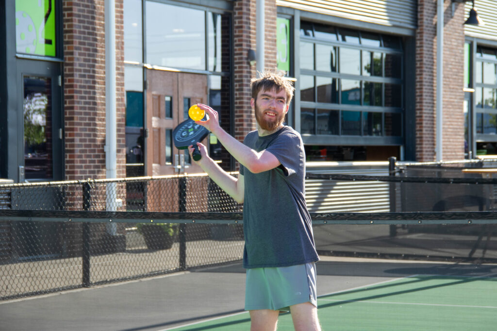 Heartspring student playing pickleball at Chicken N Pickle