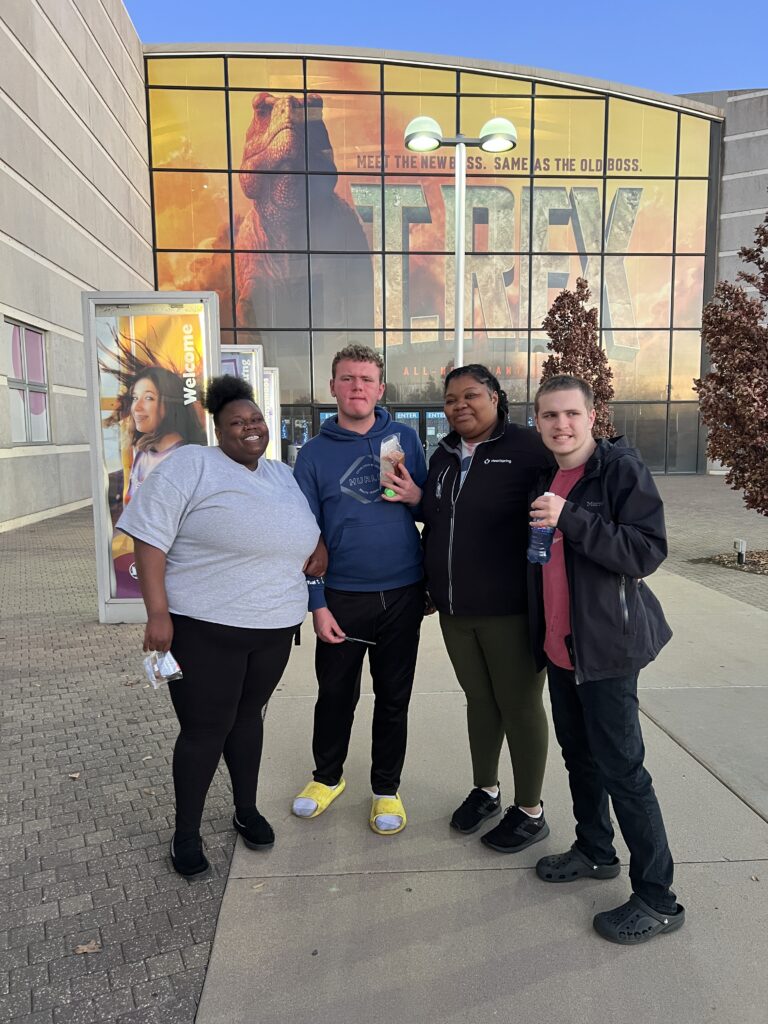 Heartspring direct support professionals and students stand outside of Exploration Place