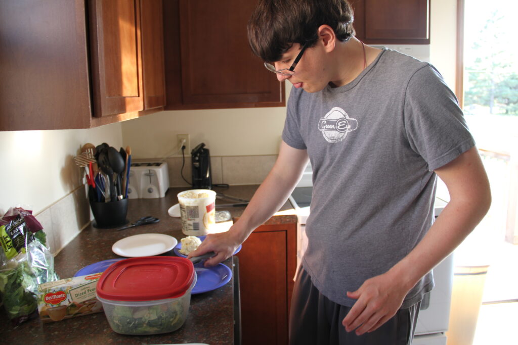 John making dinner independently in a Heartspring off-campus group home