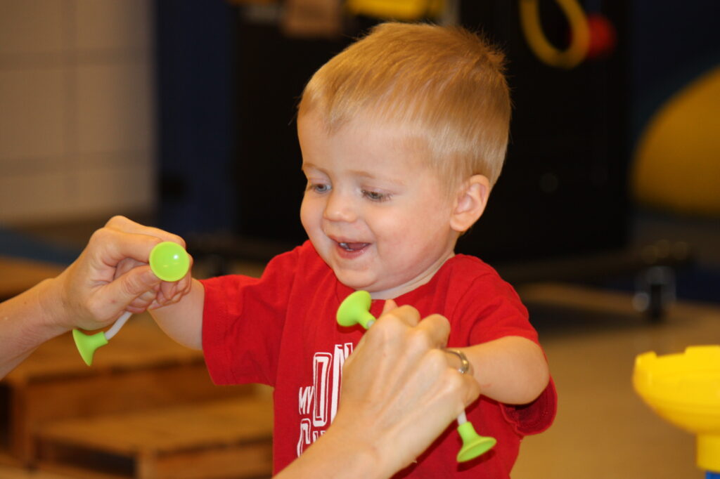Heartspring pediatric clinic client Levi working on skills with a pediatric physical therapist