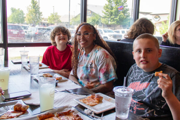 Heartspring direct support professional and students eating lunch at Ziggy's Pizza as part of the Lunch Bunch program