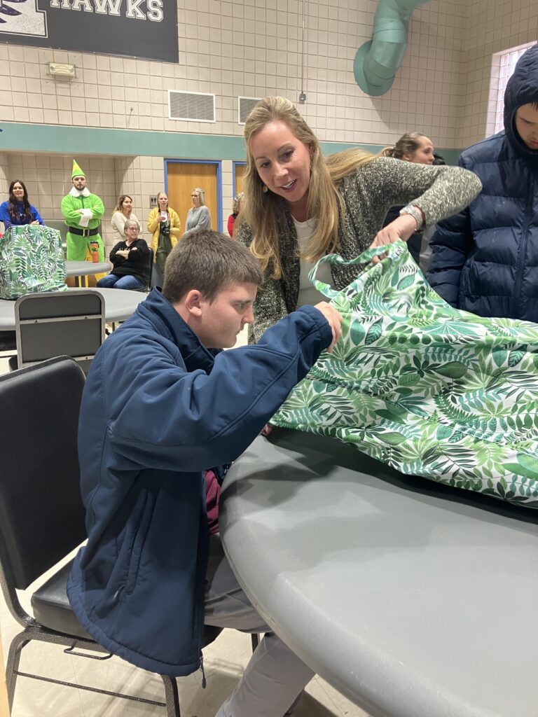 Spirit AeroSystem employee helps Heartspring student open holiday gifts at Spirit Day of Giving