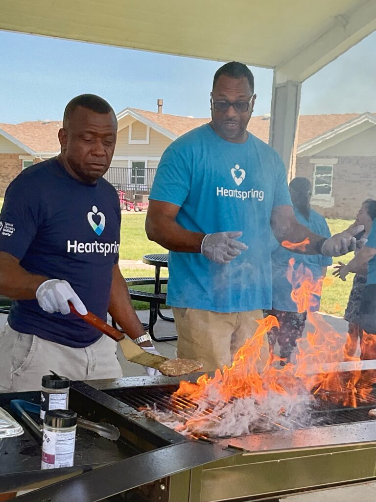 Heartspring Therapeutic Residential & Day School staff grill hamburgers and hot dogs for lunch at Family Field Day.
