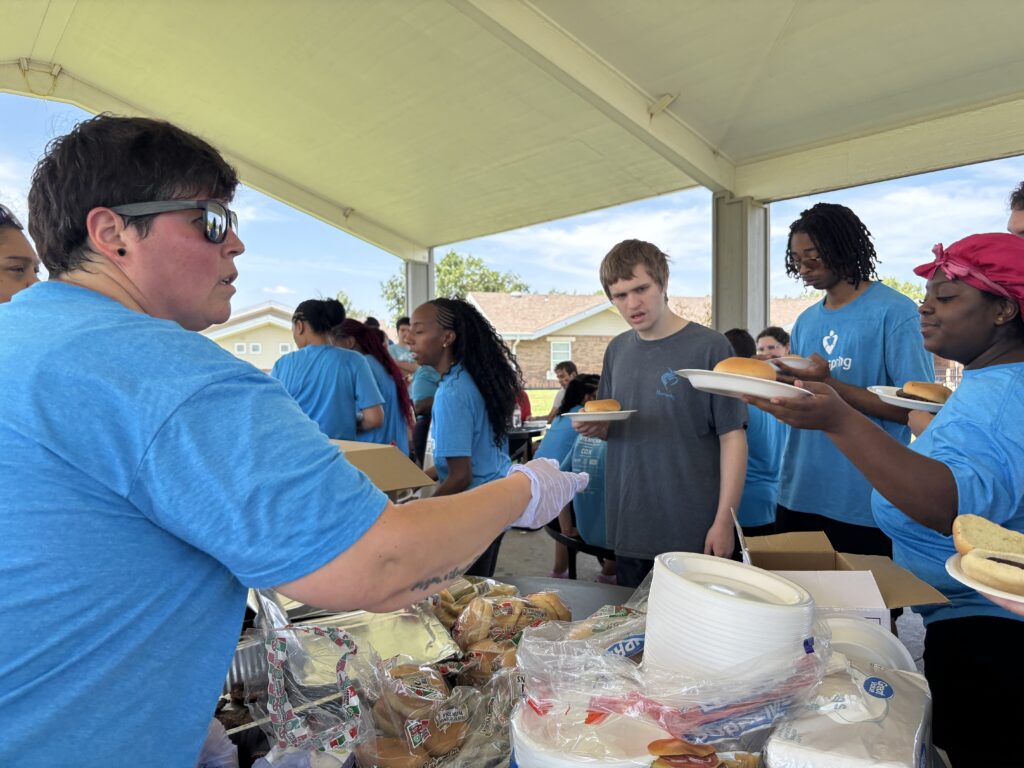 Heartspring Therapeutic Residential & Day School students and staff wait in line for food at Family Field Day.