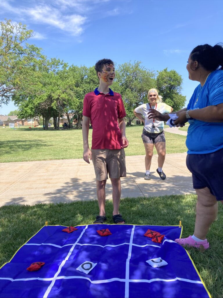 Heartspring Therapeutic Residential & Day School student plays a game of tic-tac-toe at Family Field Day.