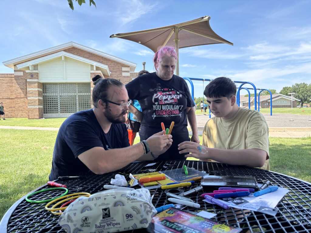 Heartspring Therapeutic Residential & Day School students and staff work on the collaborative art project at Family Field Day.