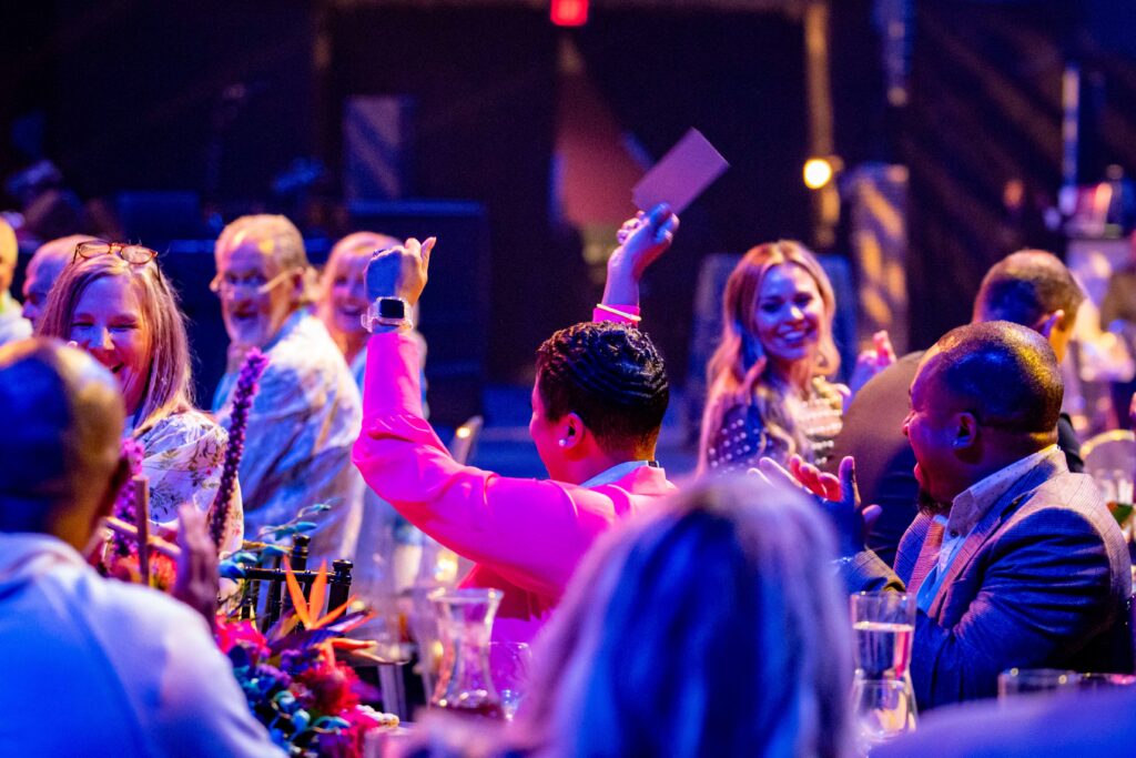 Heartspring Gala guest celebrating and holding up her winning Golden Ticket