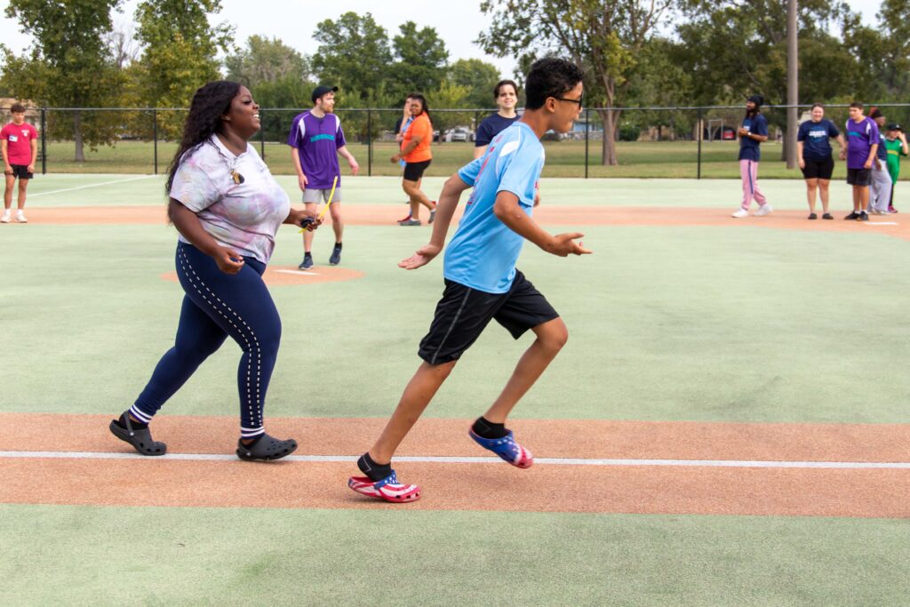 Heartspring student runs to first base in a Miracle League baseball game.