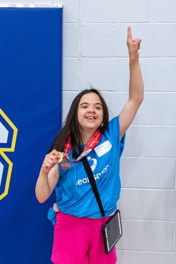 Heartspring student celebrates with her medal in the Kansas Special Olympics Track & Field event.