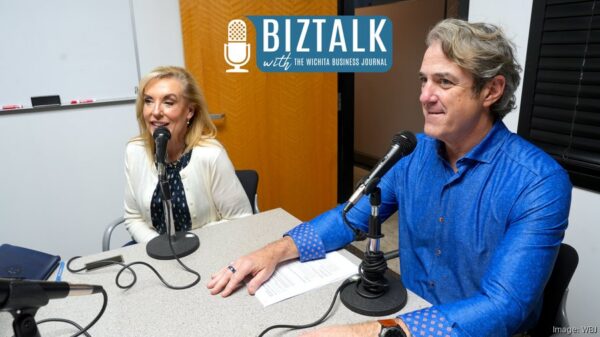 Heartspring President & CEO, Dan Soliday, and Heather Hogan, Heartspring's Chief Advancement & Startegy Officer discuss Heartspring's downtown healthcare corridor expansion with the Wichita Business Journal at a white table behind two podcast microphones.