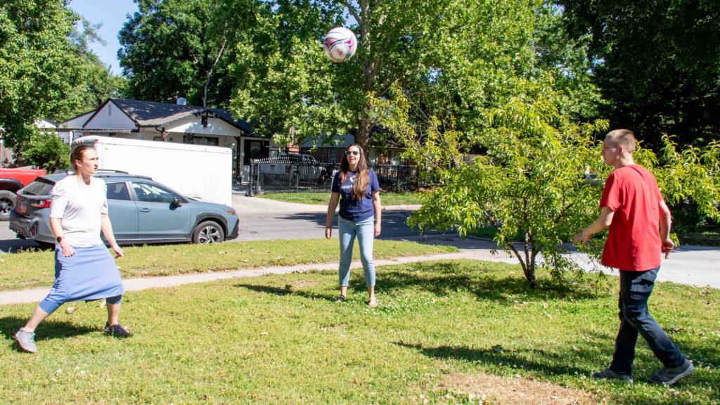 Brandon, a Heartspring Pediatric Outpatient Clinic client, plays volleyball with his occupational therapist and physical therapist.