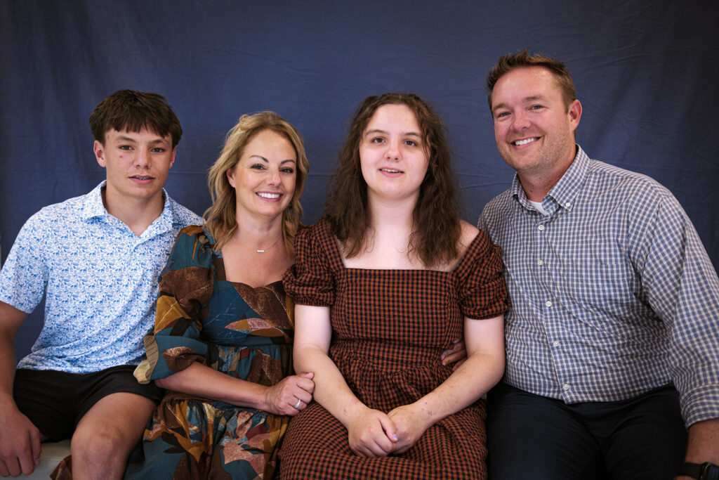 A Heartspring family sitting down posing for a family portrait