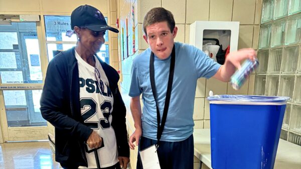 Gloria Phillips, a paraprofessional lead in the Heartspring Therapeutic School helps a student complete his recycling vocational activity.